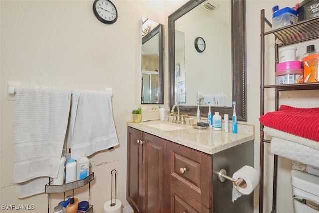 bathroom featuring vanity and toilet