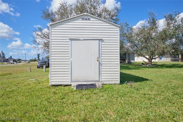 view of outdoor structure featuring a lawn