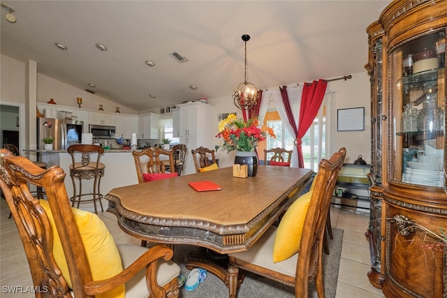 dining space with vaulted ceiling, light tile patterned flooring, and a chandelier