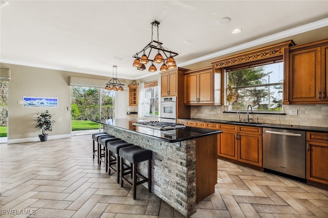 kitchen featuring a kitchen island, stainless steel appliances, and plenty of natural light