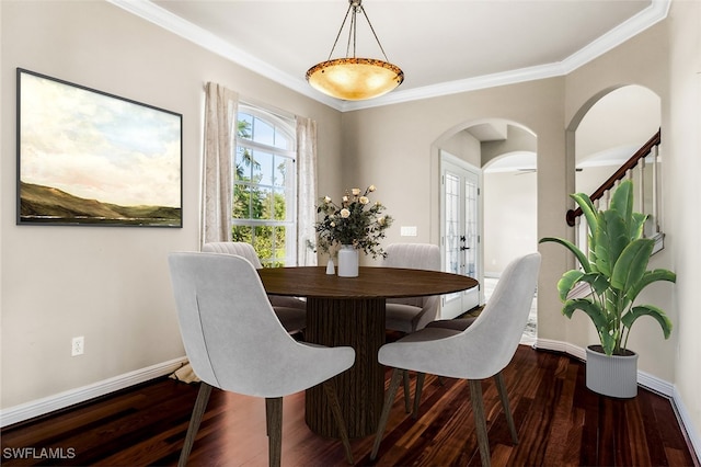 dining room featuring crown molding and dark hardwood / wood-style floors