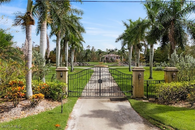 view of gate featuring a yard