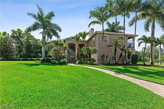 mediterranean / spanish-style house with a front yard