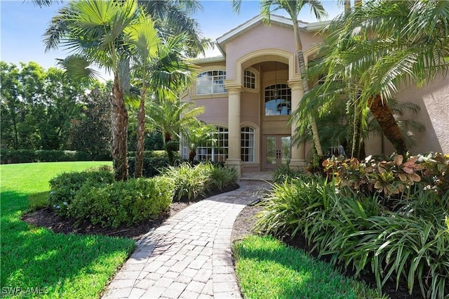 property entrance featuring french doors and a lawn