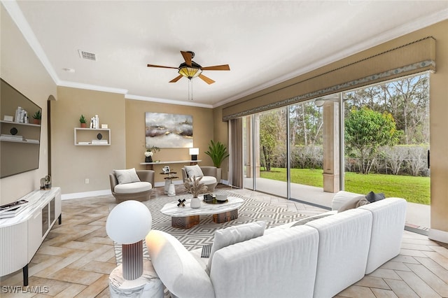 living room featuring light parquet flooring, ceiling fan, and crown molding