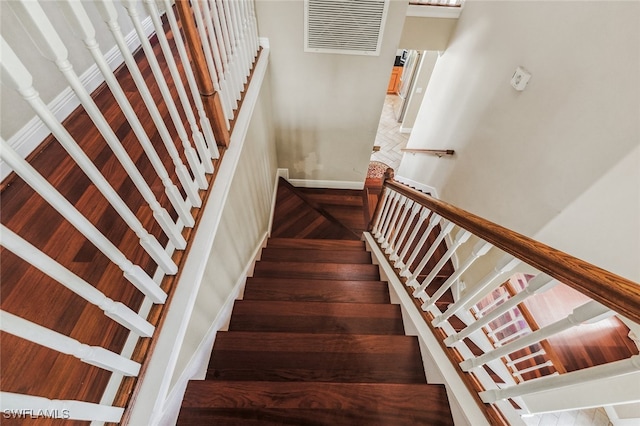 staircase with hardwood / wood-style floors