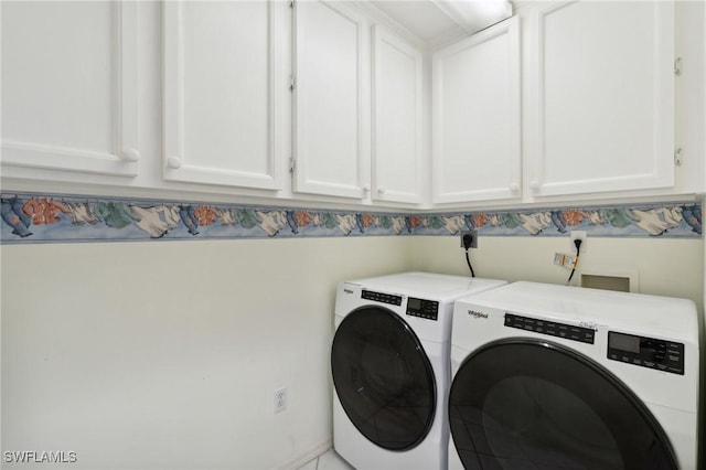 laundry area featuring cabinets and washing machine and dryer