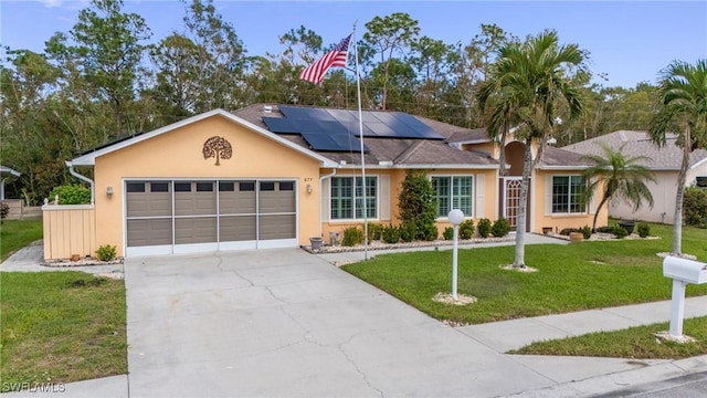 single story home featuring a garage, solar panels, and a front lawn