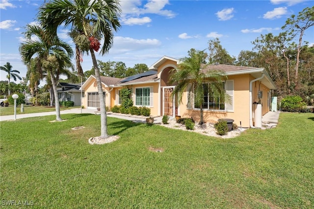 single story home with a front lawn, solar panels, and a garage