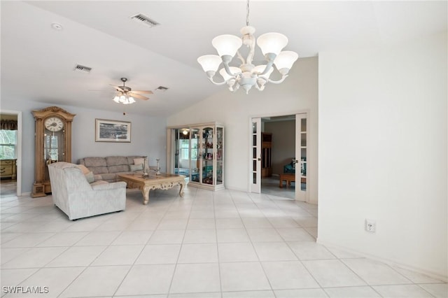 unfurnished living room featuring ceiling fan with notable chandelier, light tile patterned floors, and lofted ceiling