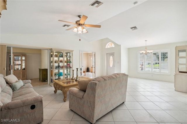 living room featuring lofted ceiling, light tile patterned flooring, and ceiling fan with notable chandelier