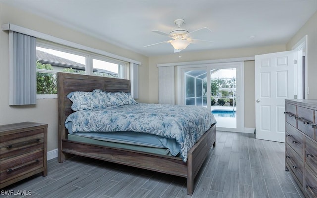 bedroom with dark hardwood / wood-style flooring, access to outside, multiple windows, and ceiling fan