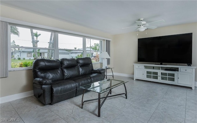 living room with ceiling fan and light tile patterned flooring