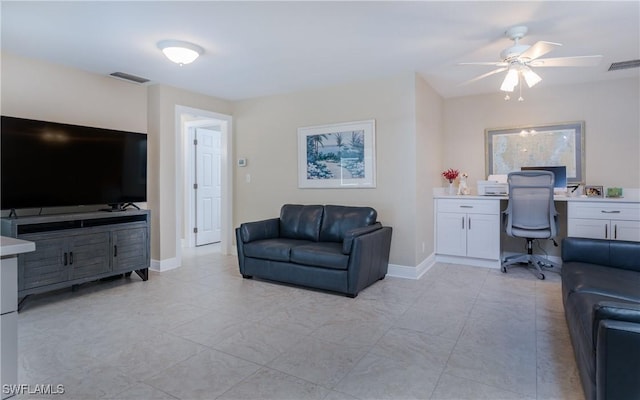 interior space featuring built in desk and ceiling fan