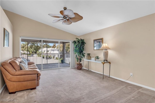 living area featuring vaulted ceiling, light colored carpet, and ceiling fan