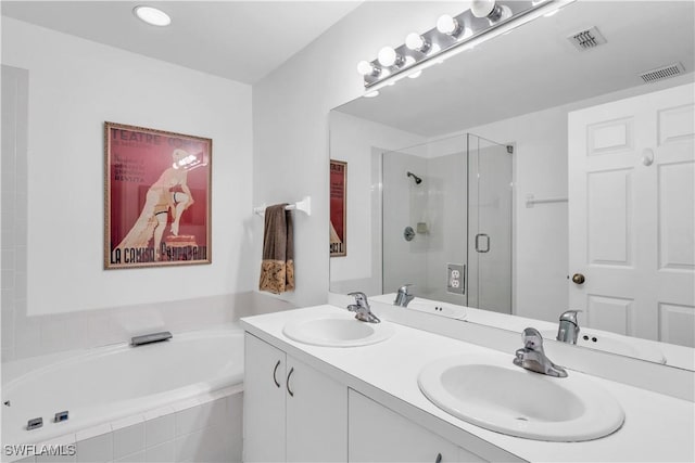 bathroom featuring vanity and shower with separate bathtub