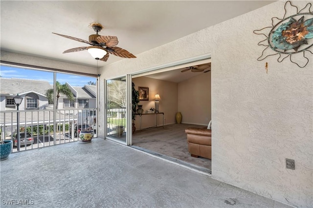 interior space featuring a balcony and ceiling fan