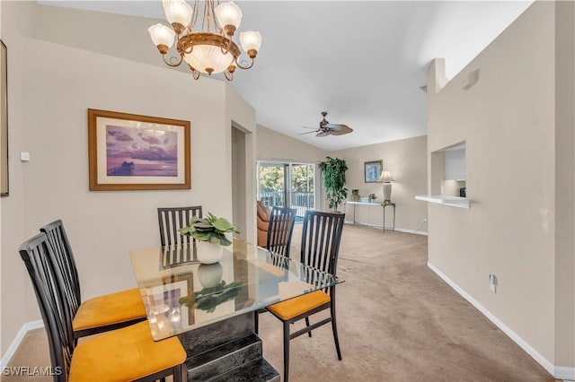 dining room featuring lofted ceiling, ceiling fan with notable chandelier, and light carpet