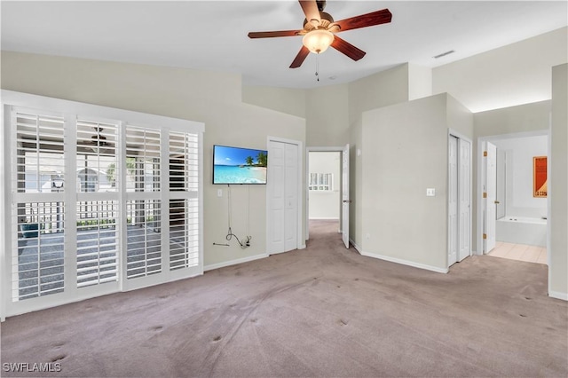 spare room with high vaulted ceiling, light colored carpet, and ceiling fan