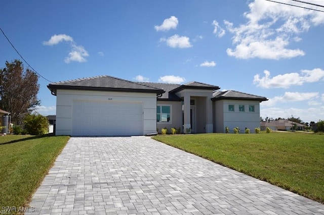 view of front of home with a garage and a front lawn