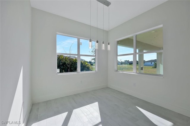 unfurnished room featuring wood finished floors and baseboards