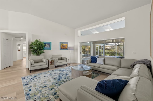 living room featuring lofted ceiling and light wood-type flooring