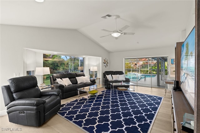 living room with lofted ceiling, hardwood / wood-style floors, and ceiling fan