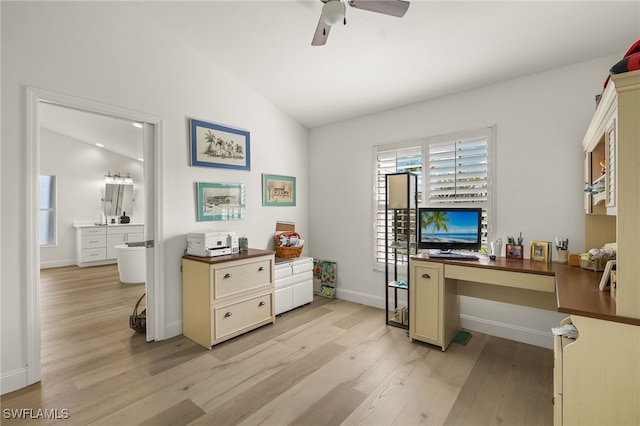 home office with built in desk, vaulted ceiling, light hardwood / wood-style floors, and ceiling fan