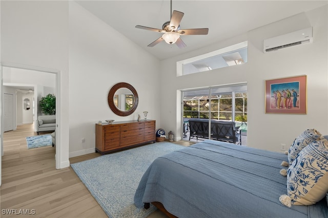 bedroom with a wall mounted AC, ceiling fan, access to exterior, high vaulted ceiling, and light hardwood / wood-style flooring