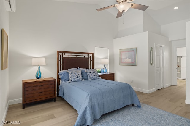 bedroom with high vaulted ceiling, light hardwood / wood-style floors, and ceiling fan