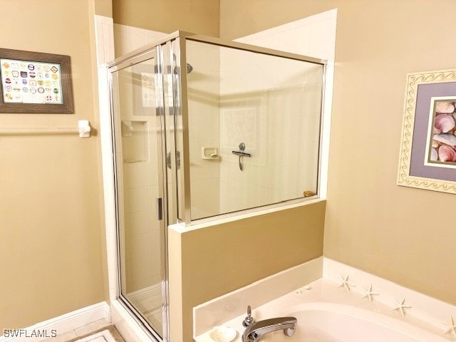 bathroom featuring plus walk in shower