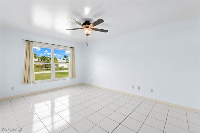 tiled spare room with ceiling fan