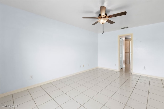 tiled spare room with ceiling fan