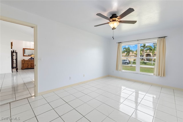 tiled spare room featuring ceiling fan