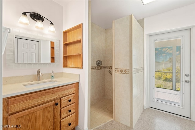 bathroom with vanity and tiled shower