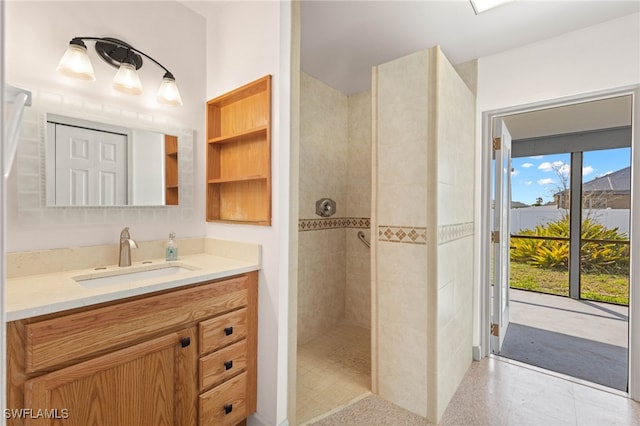 bathroom featuring vanity and tiled shower