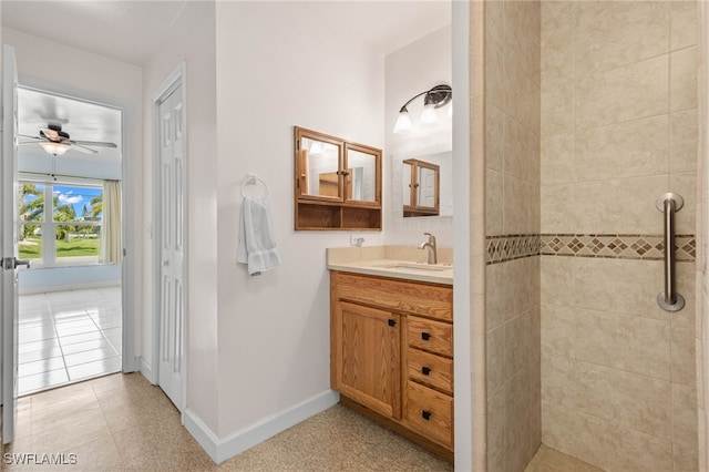 bathroom featuring vanity, a tile shower, tile patterned flooring, and ceiling fan