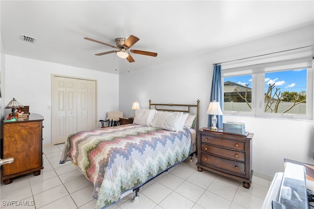 tiled bedroom featuring a closet and ceiling fan