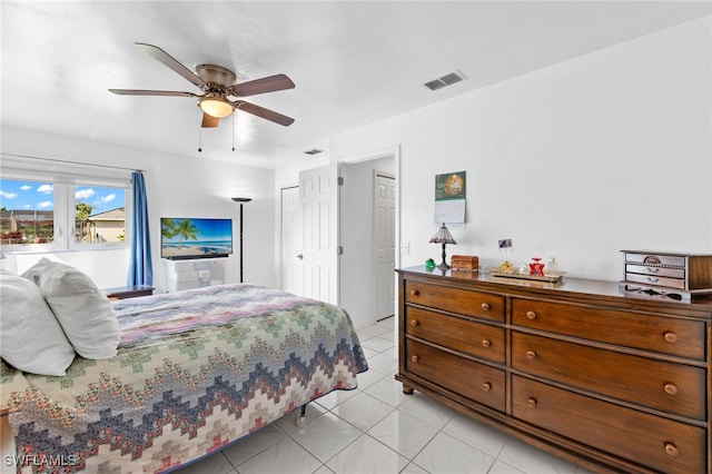 tiled bedroom featuring ceiling fan