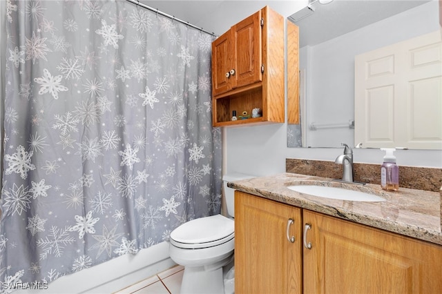 full bathroom featuring vanity, shower / bath combo with shower curtain, toilet, and tile patterned flooring