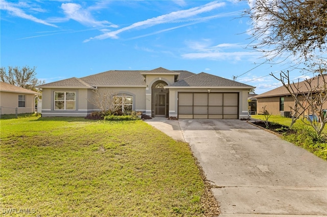 view of front of house with a front yard and a garage