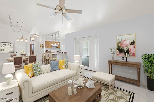 tiled living room featuring ceiling fan with notable chandelier