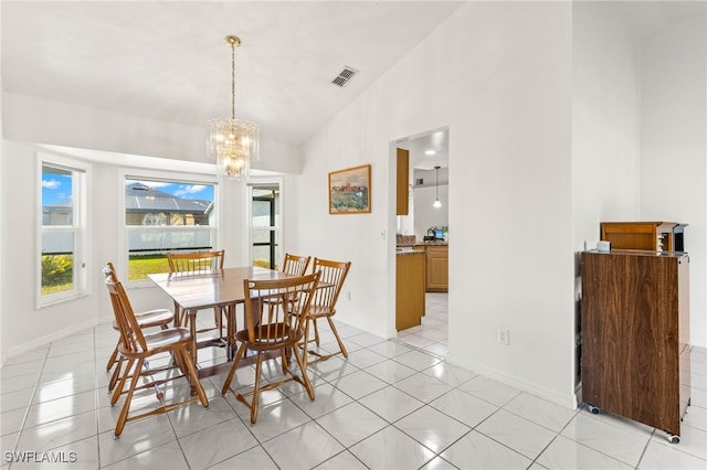 dining space featuring a notable chandelier, high vaulted ceiling, and light tile patterned floors