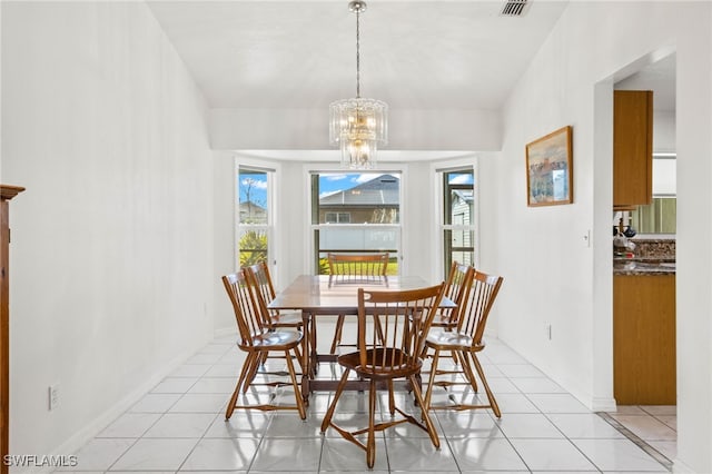 dining area featuring a chandelier and light tile patterned flooring