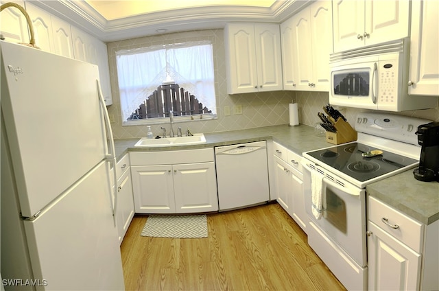 kitchen with white appliances, white cabinetry, sink, and light hardwood / wood-style floors