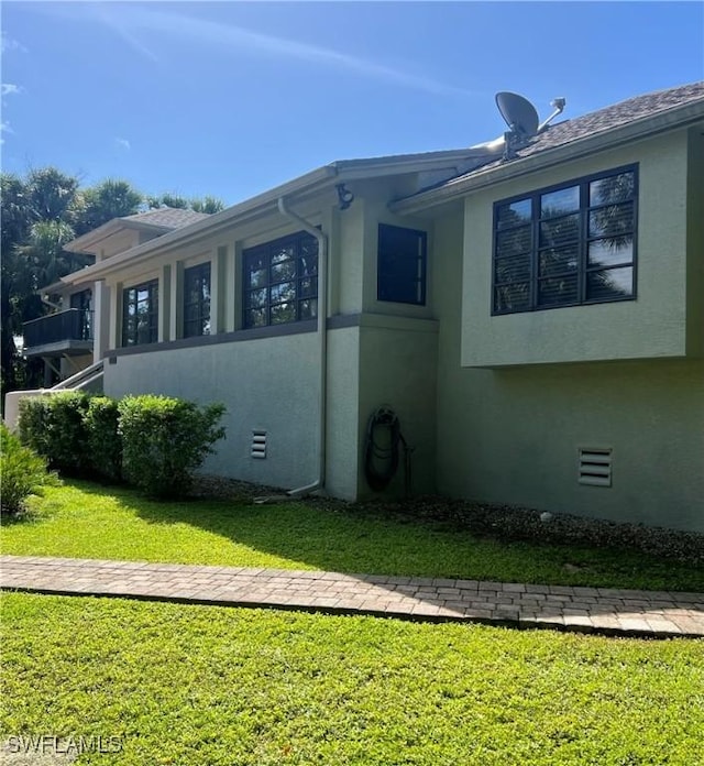 view of home's exterior with a yard