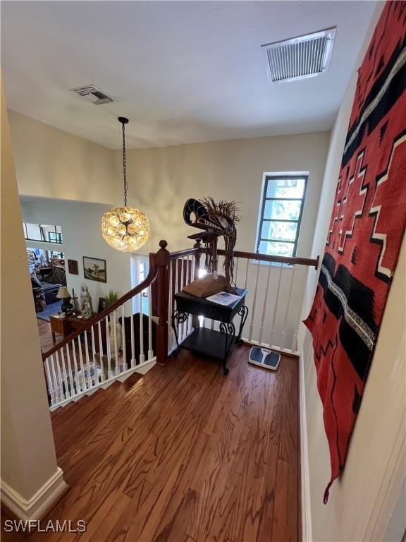 entryway featuring hardwood / wood-style flooring and an inviting chandelier