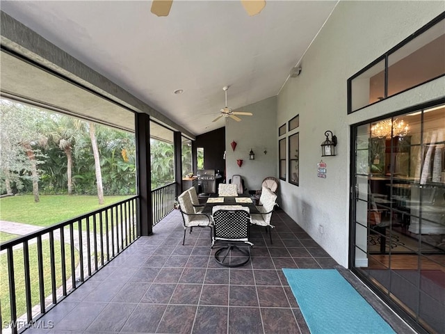 sunroom featuring ceiling fan and lofted ceiling