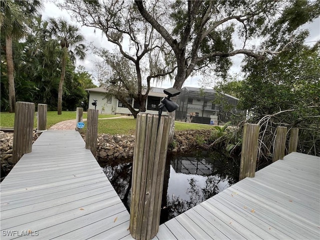 dock area featuring a water view and a lanai