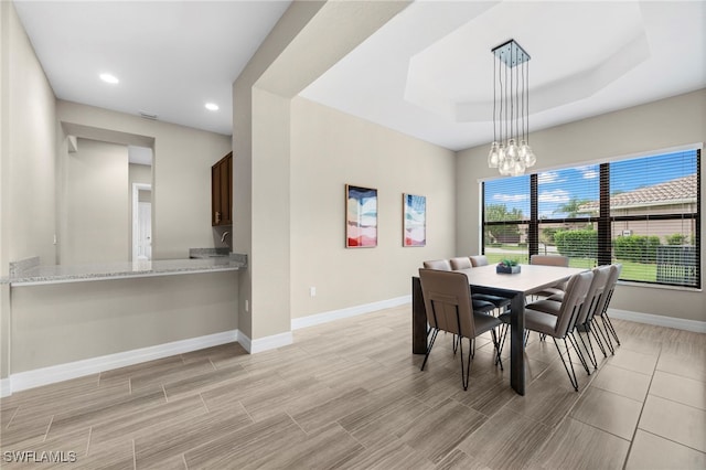 4365 Caldera Cir, Naples, FL 34119 - dining room with baseboards, a chandelier, recessed lighting, a tray ceiling, and wood tiled floors